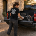 Installer loading tile and tools while wearing the black Falco + Petra FP Global Shirt