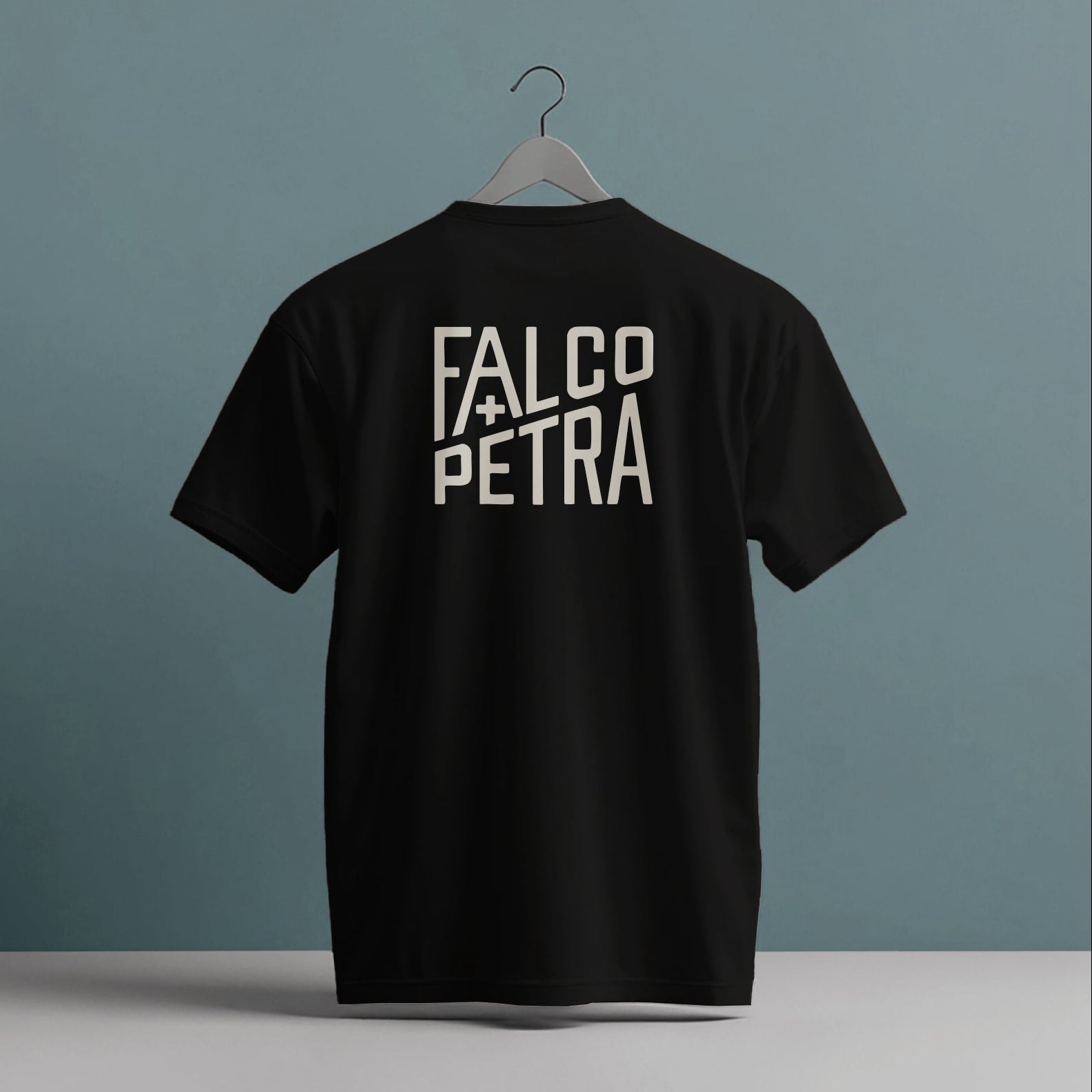 Black t-shirt with 'Falco Petra' text on a gray background