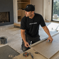 Installer wearing the black Falco + Petra Carry the Standard Shirt