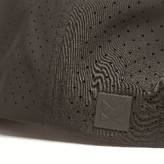 Laser-perforated rear panel detail on black performance snapback